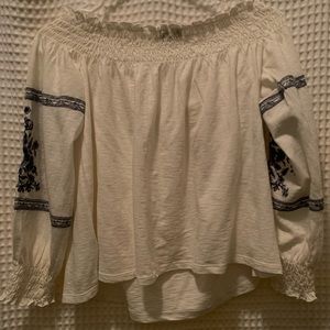 Perfect blouse for really any event. Off the solder shirt with blue flowers